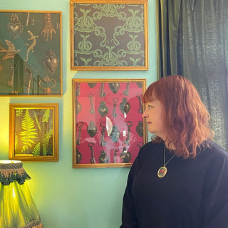 Email Jost looking at her designs hung on a wall