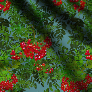 pattern of red rowan brries and green leaves on blue background