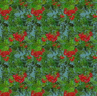 pattern of red rowan berries and green leaves on blue background