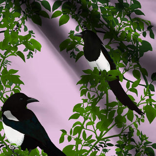 pattern of 2 magpies on green branches on pale pink background shown on fabric